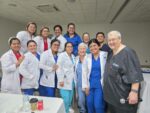 Group photo of about a dozen nurses and therapists in Managua