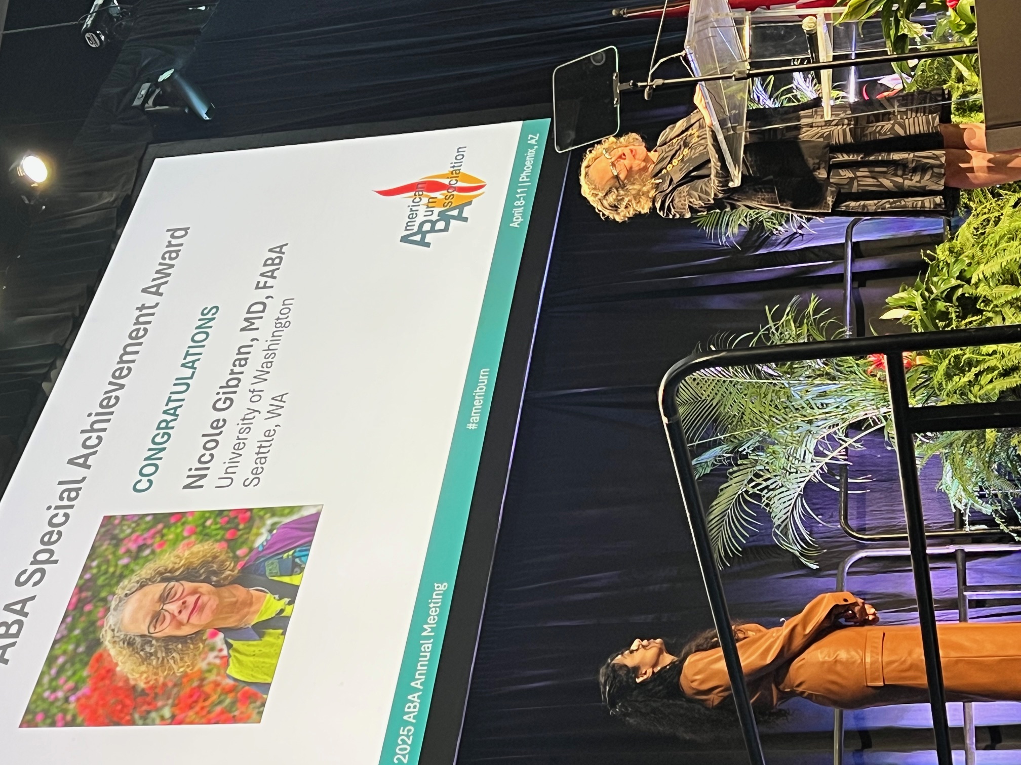 Dr. Nicole Gibran giving a speech in front of an ABA 2025 conference banner