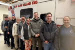 San Juan Island EMS and Burn Center team group photo in front of San Juan EMS aid vehicle